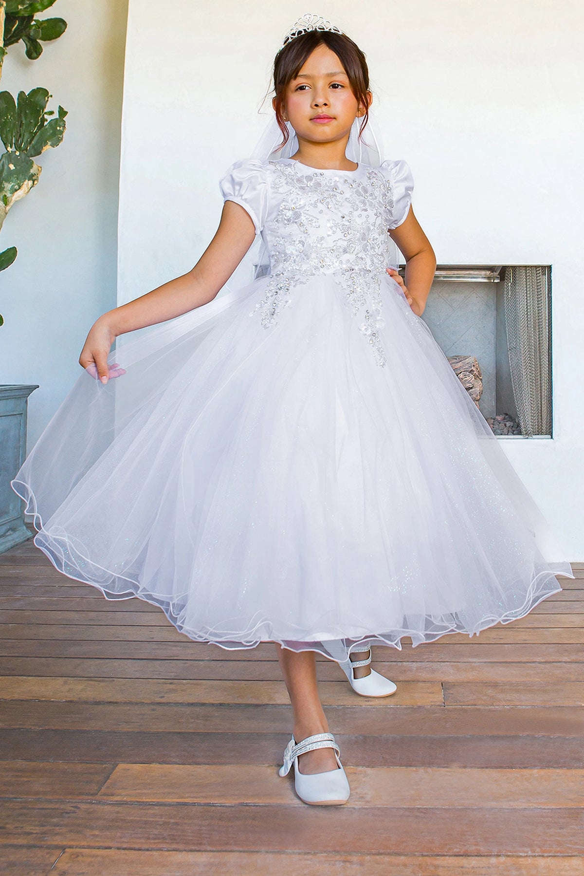 Puffed satin sleeves frame the rounded neckline of this White communion dress.