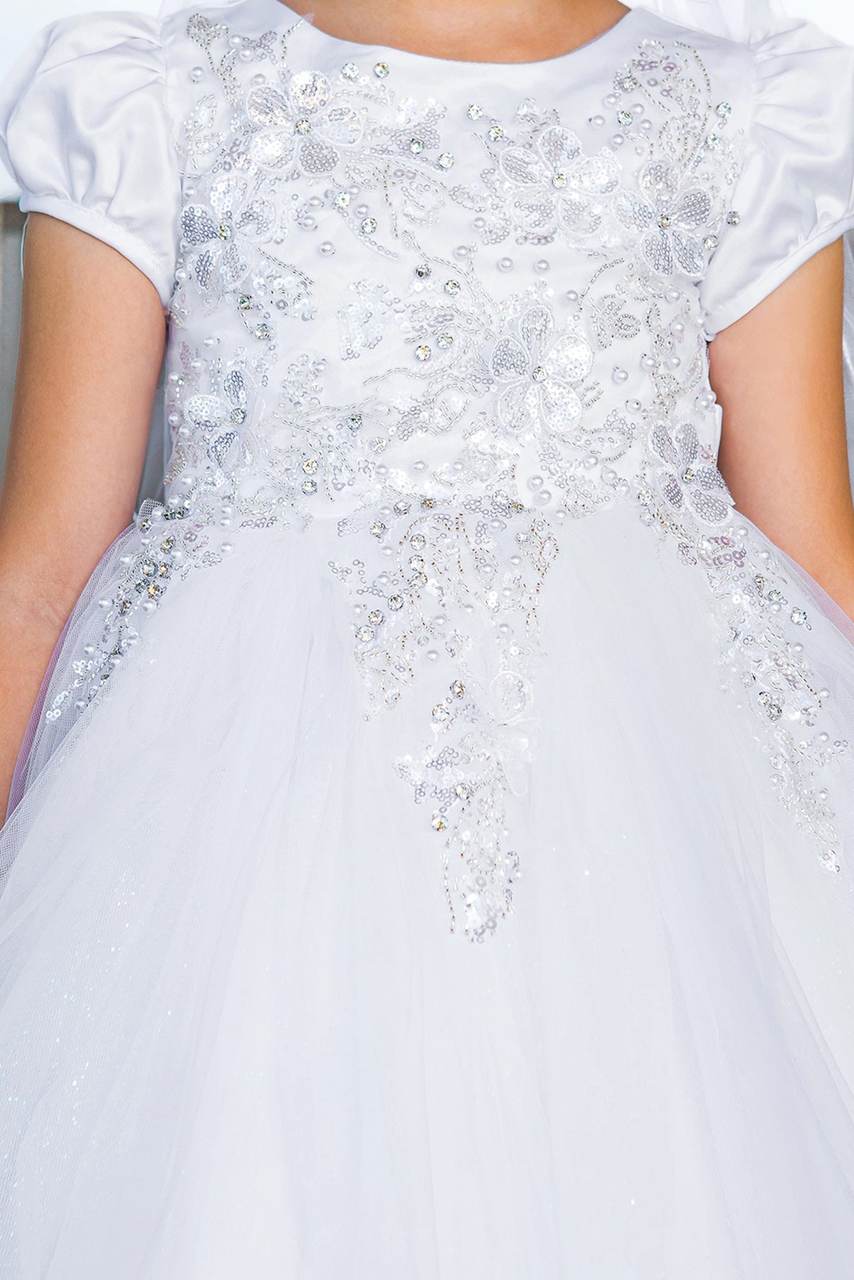 Beaded flower appliques decorate the White communion dress bodice.