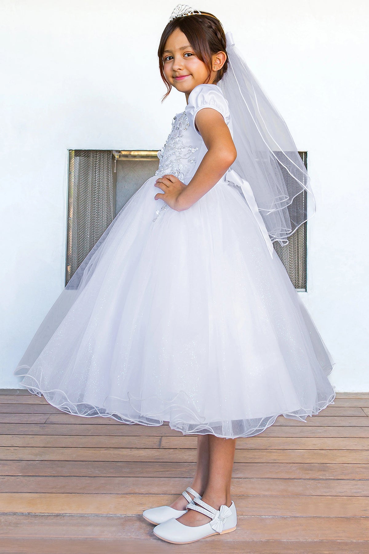 Full skirt gathers below the floral bodice on this White communion dress.