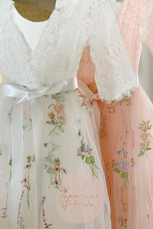 Two lace dresses with floral embroidery, one white and one pink. Flower girl dress.