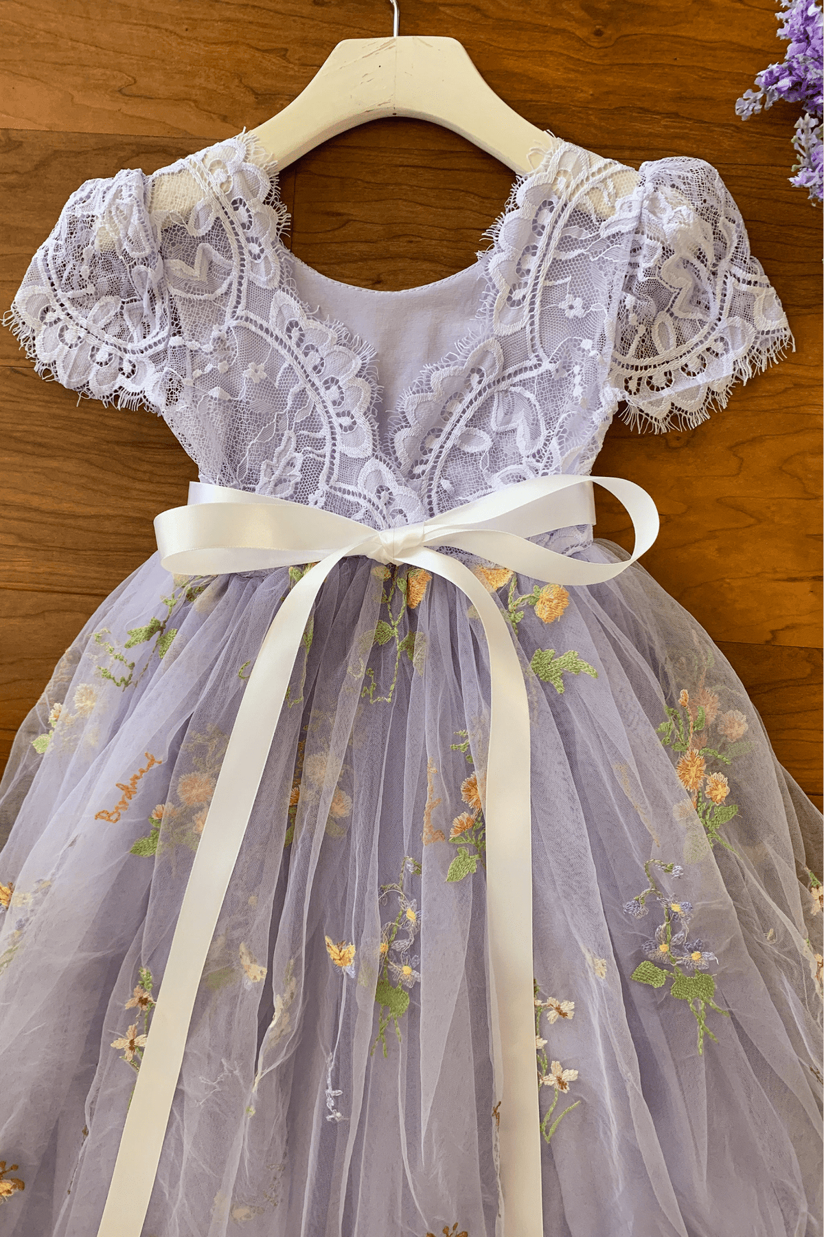 Lavender lace flower girl dress with floral embroidery.