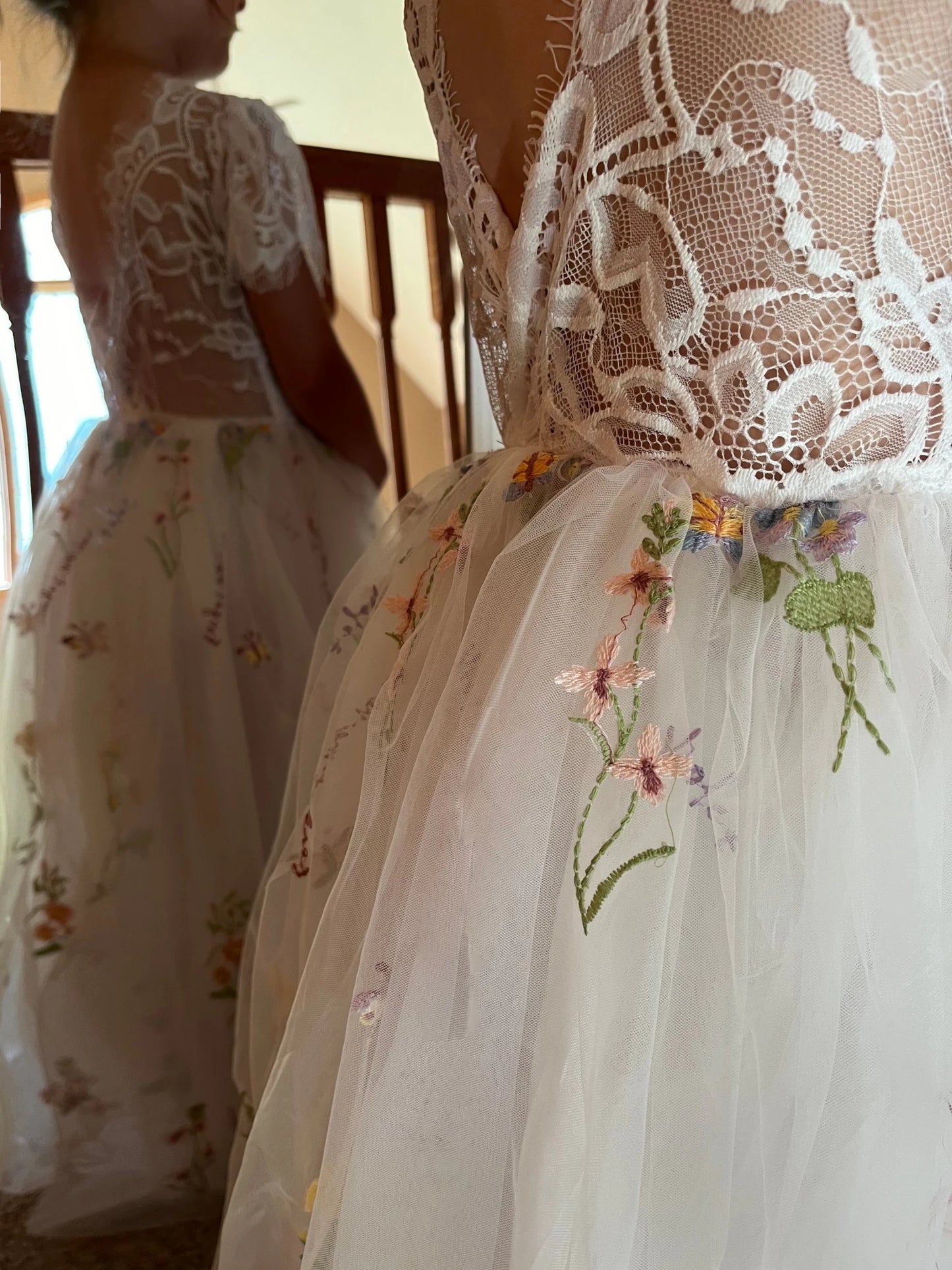 Close-up of Off-White Boho flower girl dress with Lace Bodice and Embroidered Butterfly & Floral Tulle V-Back.