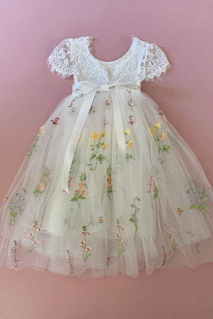Detailed view highlights Boho lace flower girl dress with floral embroidery.