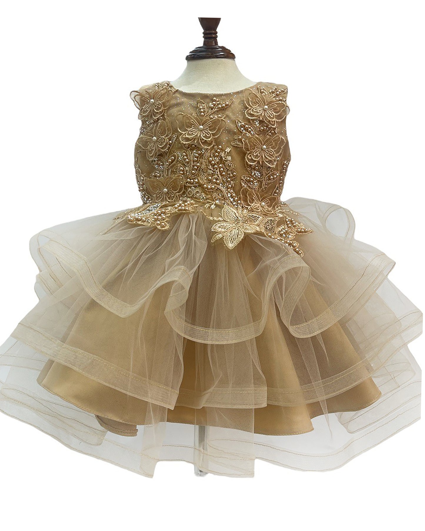 Gold lace dress on a mannequin with a white background