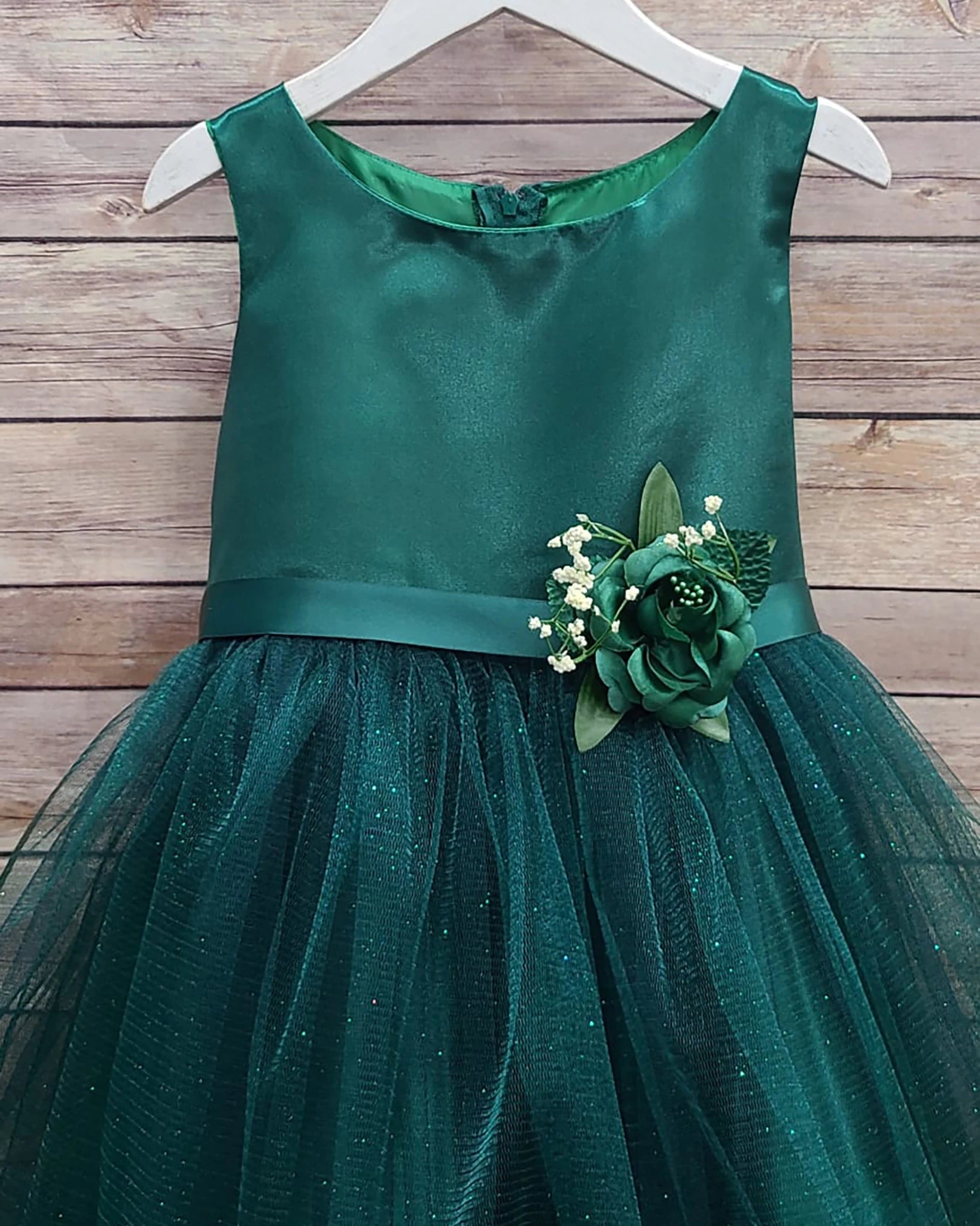 Green flower girl dress with floral embellishment.