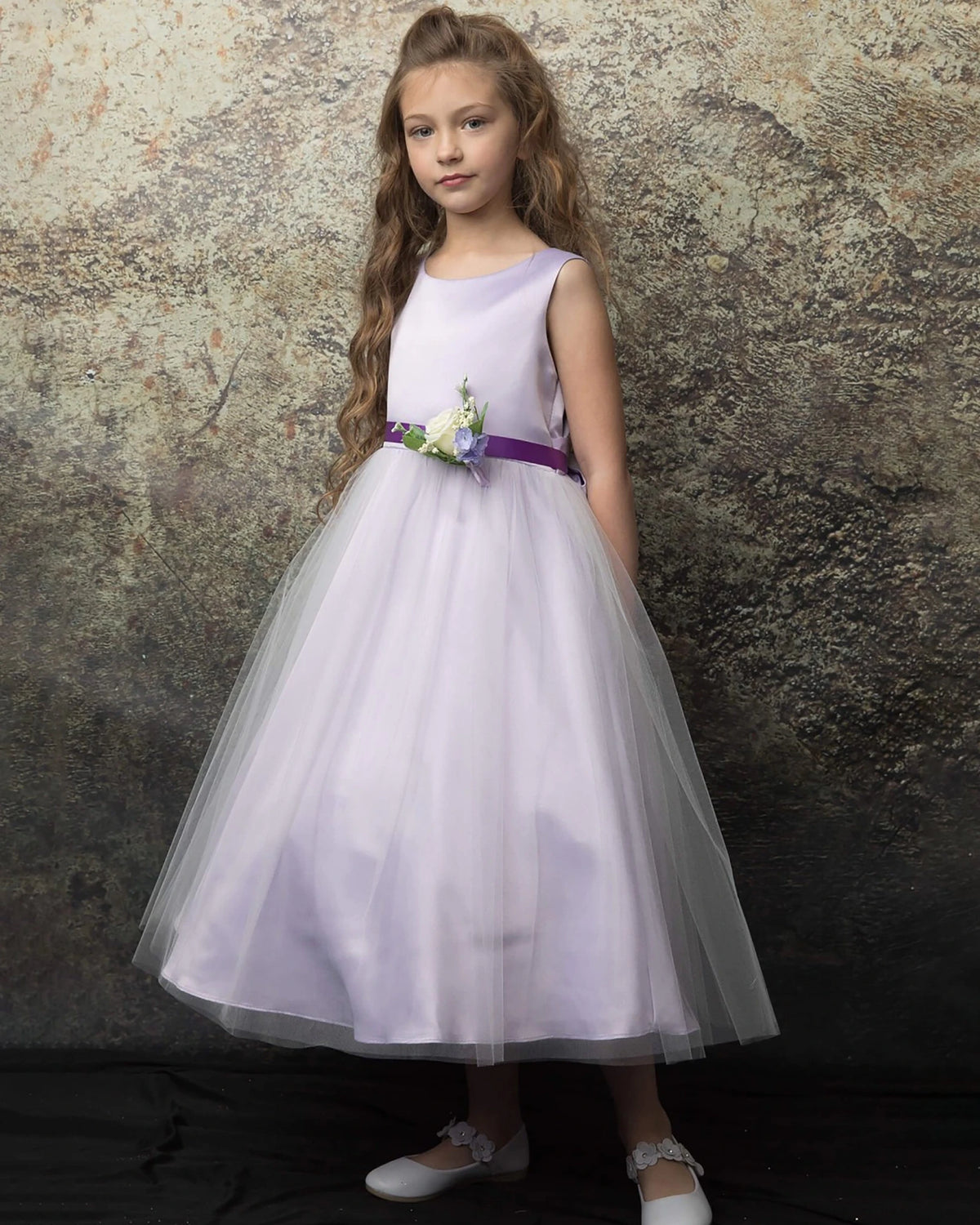 A lilac flower girl dress with purple flower belt.