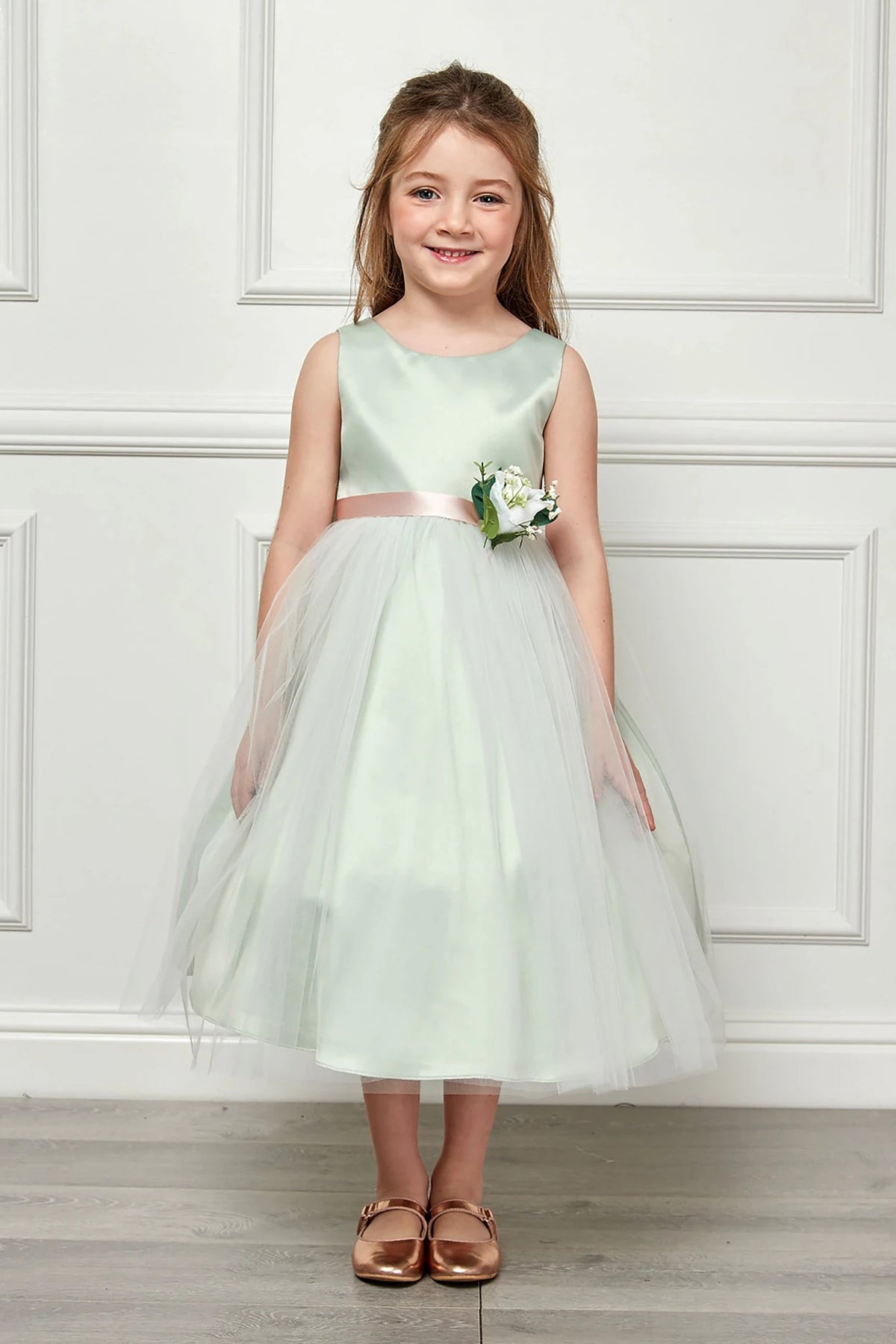 Refined styling highlights a light Sage flower girl dress.