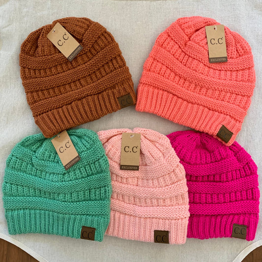 Rust, orange, green, pink and fuchsia women's winter beanies.