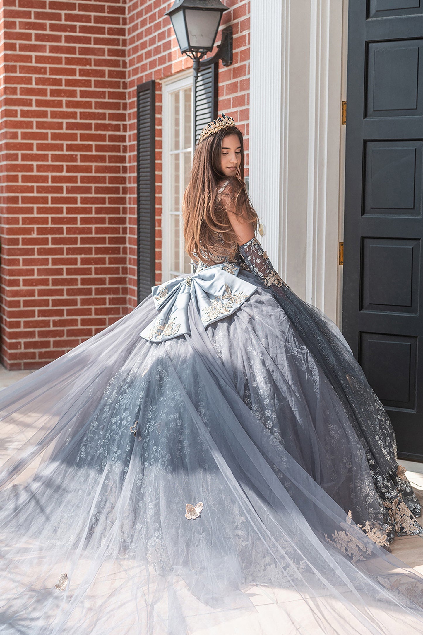 Quinceañera | Gray Black Metallic 3D Butterfly Big Ribbon Mesh Ball Gown with Waist Drape | Rafaela dress girl looking back 