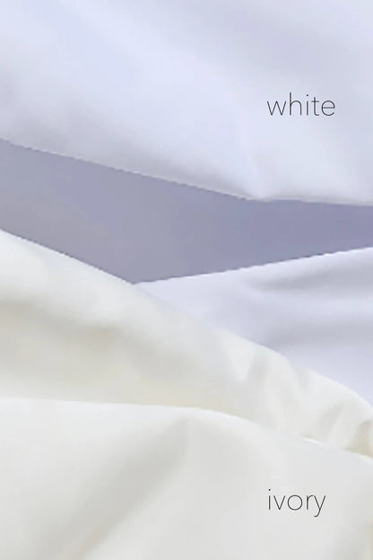 Close-up of white fabric with 'white' and 'ivory' labels
