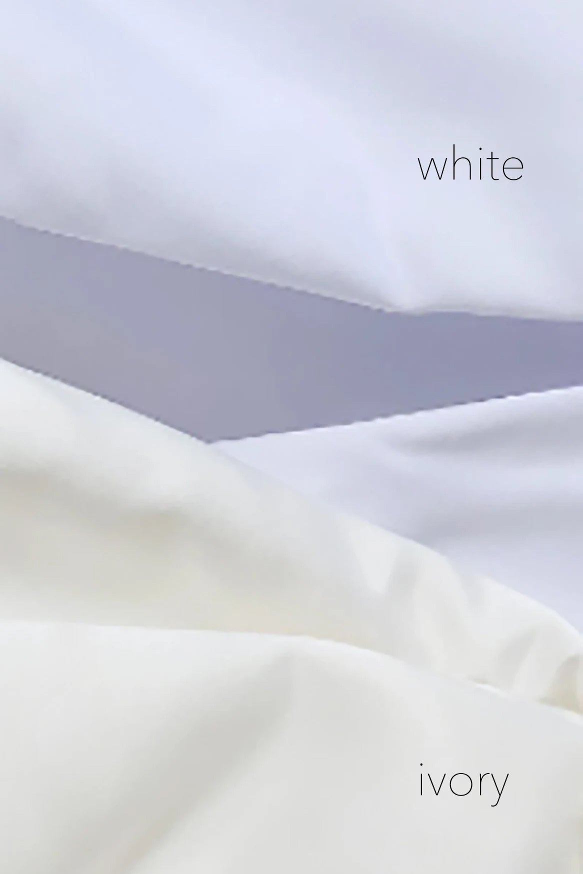 Close-up of white fabric with 'white' and 'ivory' labels. Flower girl dress. Also suitable as a communion dress. Also suitable as a baptism dress.