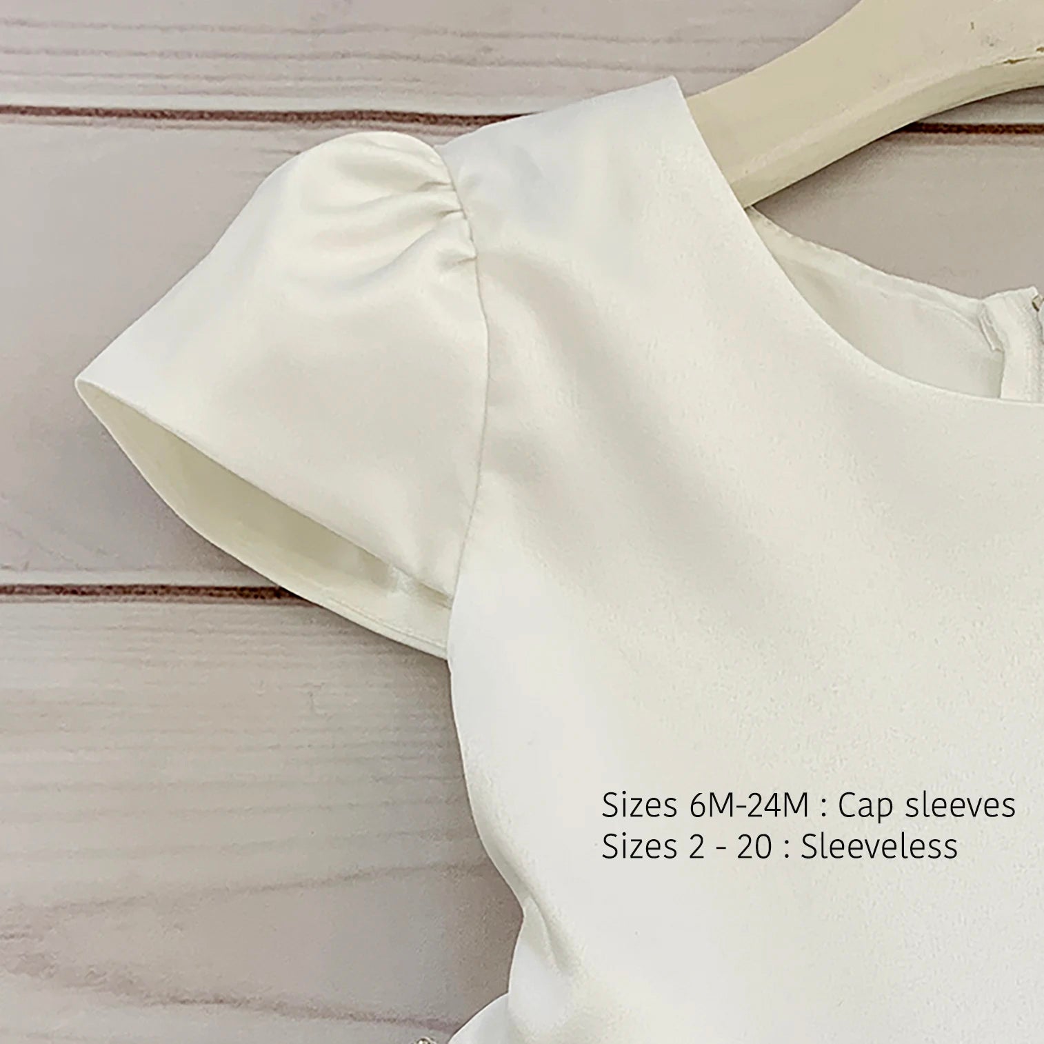 Ivory satin flower girl dress with cap sleeves and round neckline. Also suitable as a communion dress. Also suitable as a baptism dress.