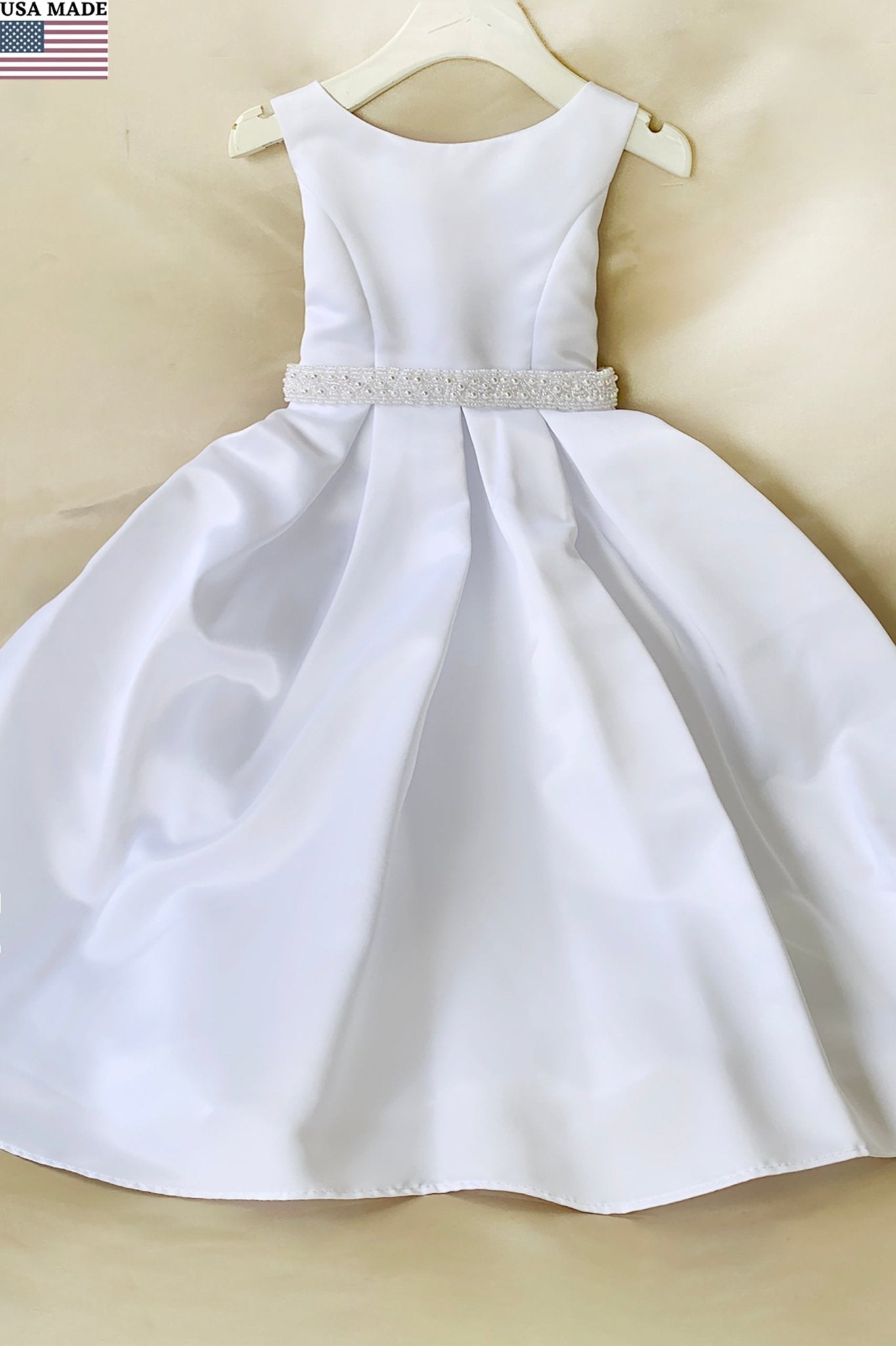 White satin flower girl communion dress with a beaded waistband. Also suitable as a flower girl dress. Also suitable as a baptism dress.