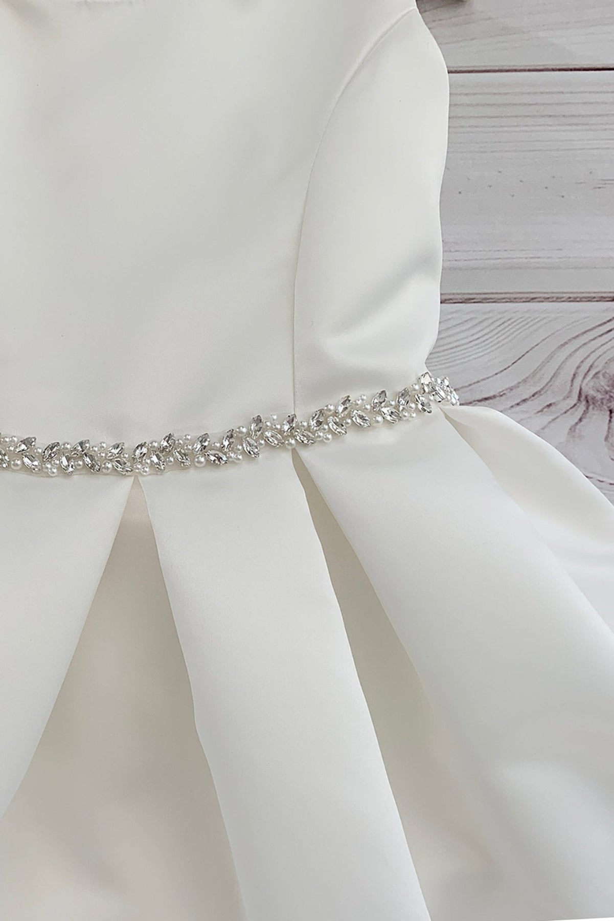 White satin flower girl communion dress with a decorative belt. Also suitable as a flower girl dress. Also suitable as a baptism dress.