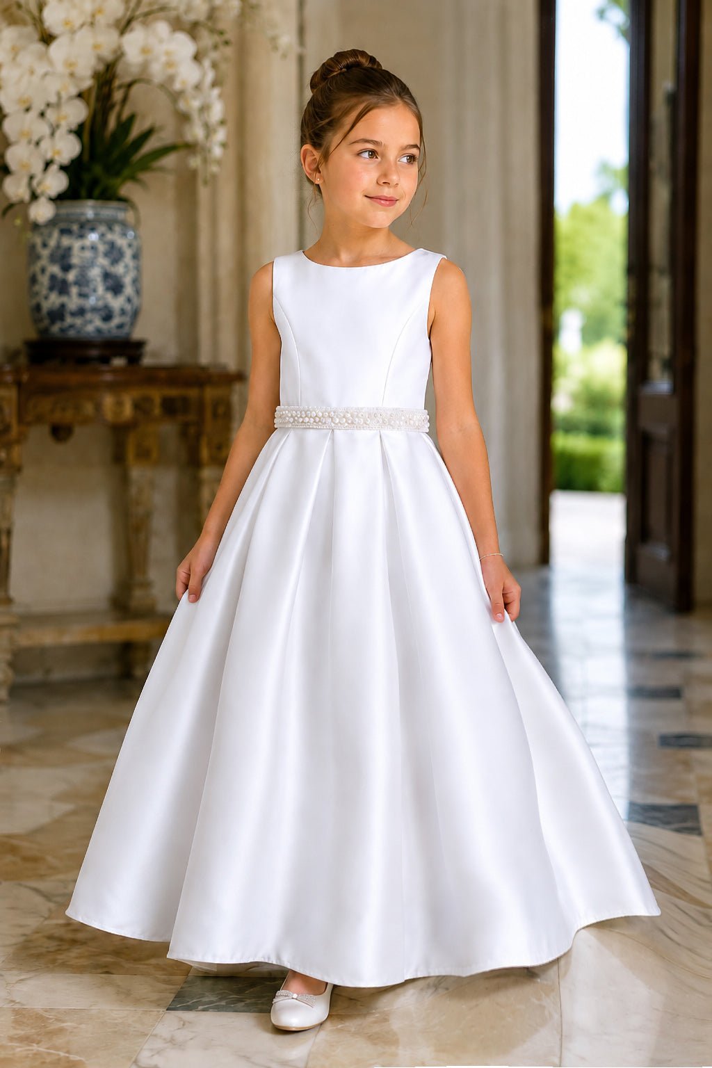 A white satin flower girl dress with pearl belt. Also suitable as a communion dress. Also suitable as a baptism dress.