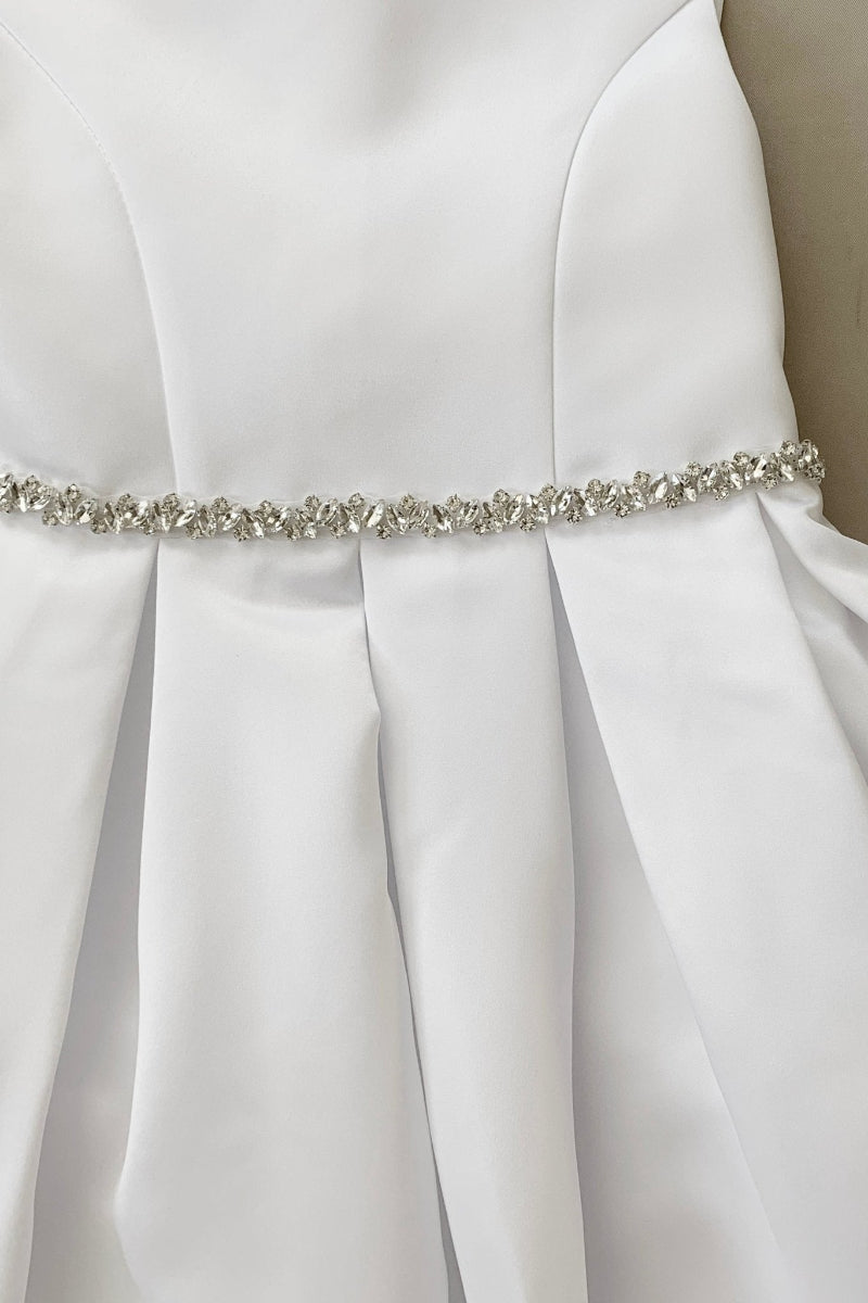 White satin kids' dress with a silver rhinestone belt 