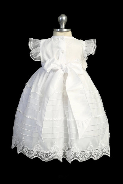 Detail of the ivory christening dress showing embroidered stripes, pearls and rhinestones on the tulle skirt.