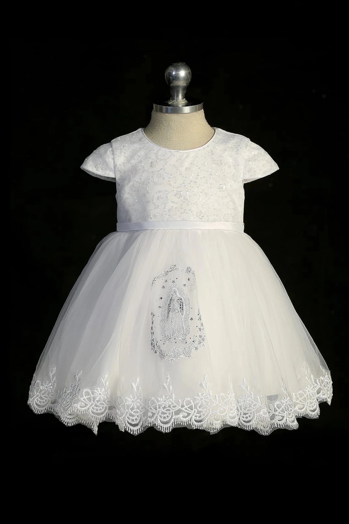 Another view of the white baptism dress with cap-sleeved sequined bodice and a thin satin sash.