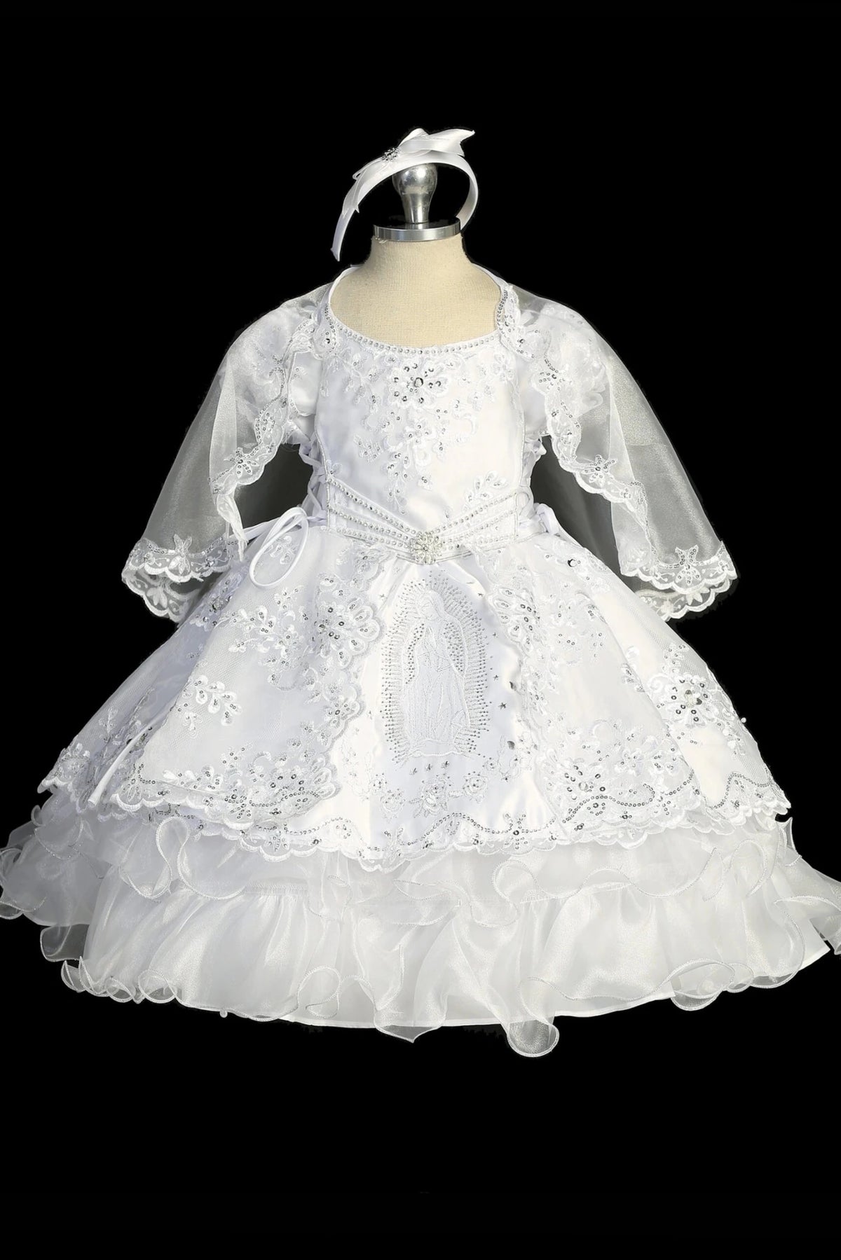 White baptism dress with long-sleeved lace bodice and an embellished waist.