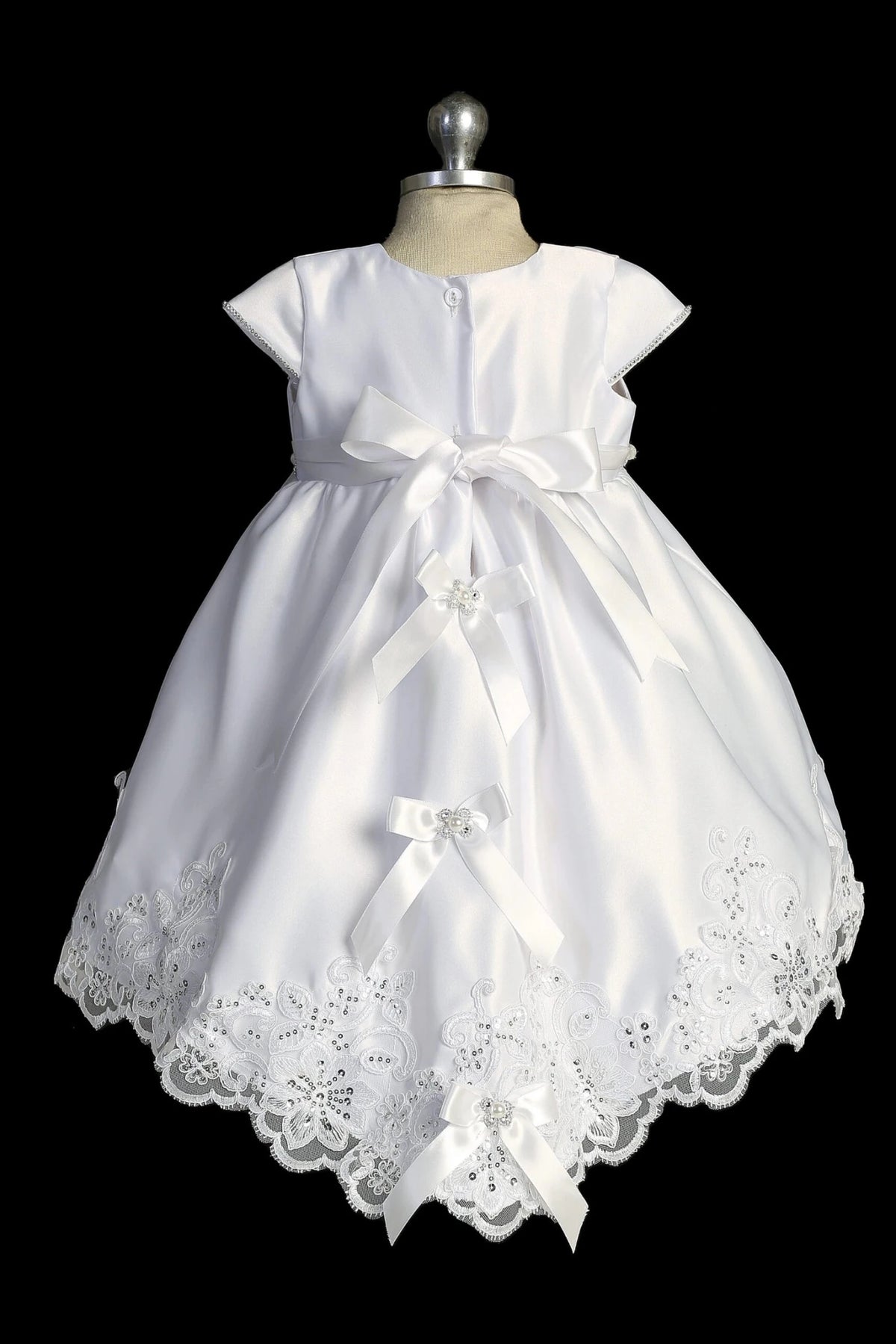 Back view of the White christening dress showing large satin back bow and lace-trimmed vest.