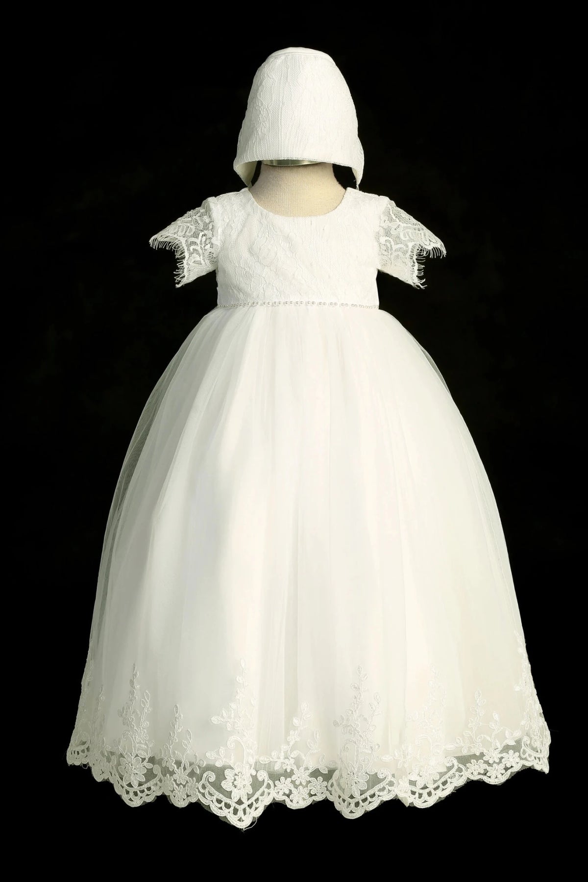 Ivory christening dress with soft lace sleeves and a pearl waist accent.