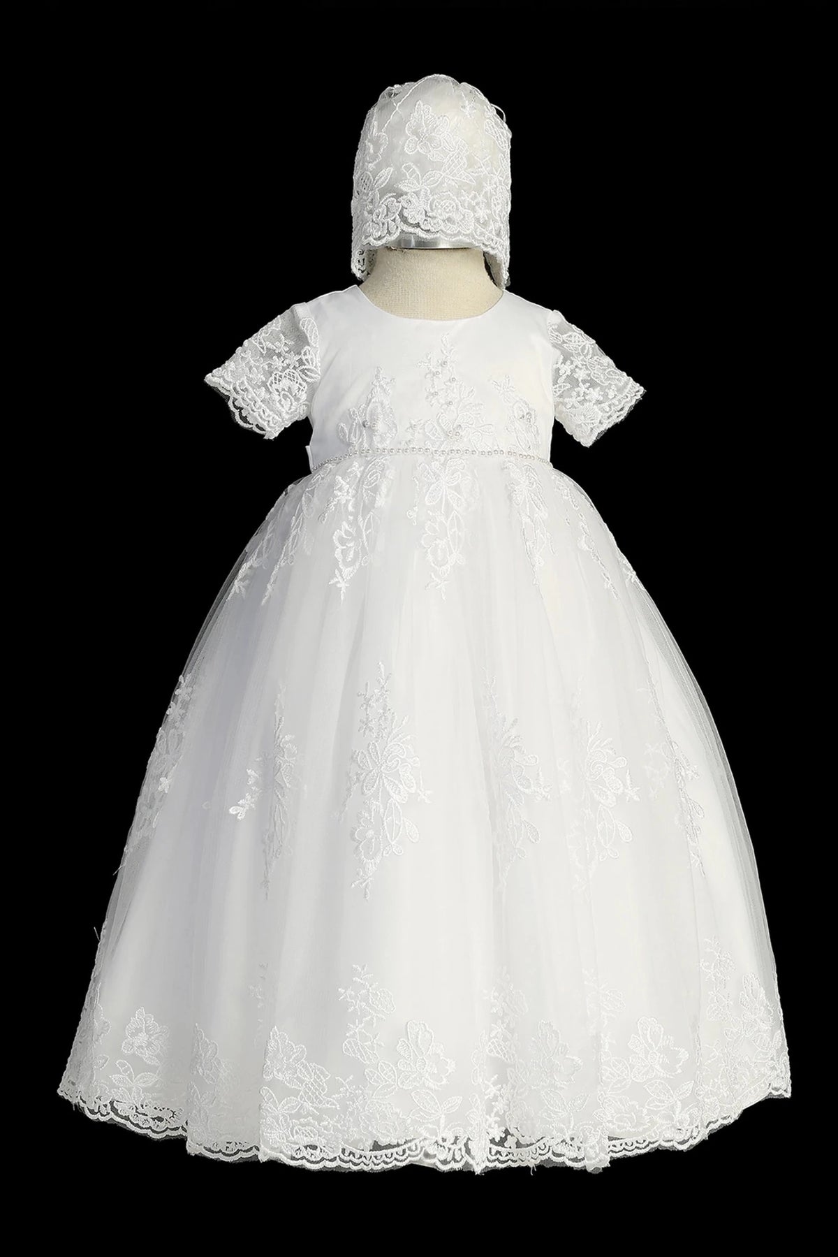 White christening dress with short-sleeved lace bodice and pearl waist accents.