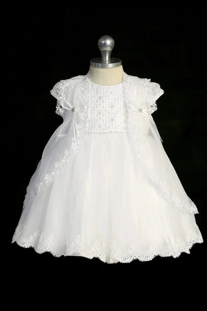 White christening dress with cap-sleeved embroidered bodice and a pearl waist accent.