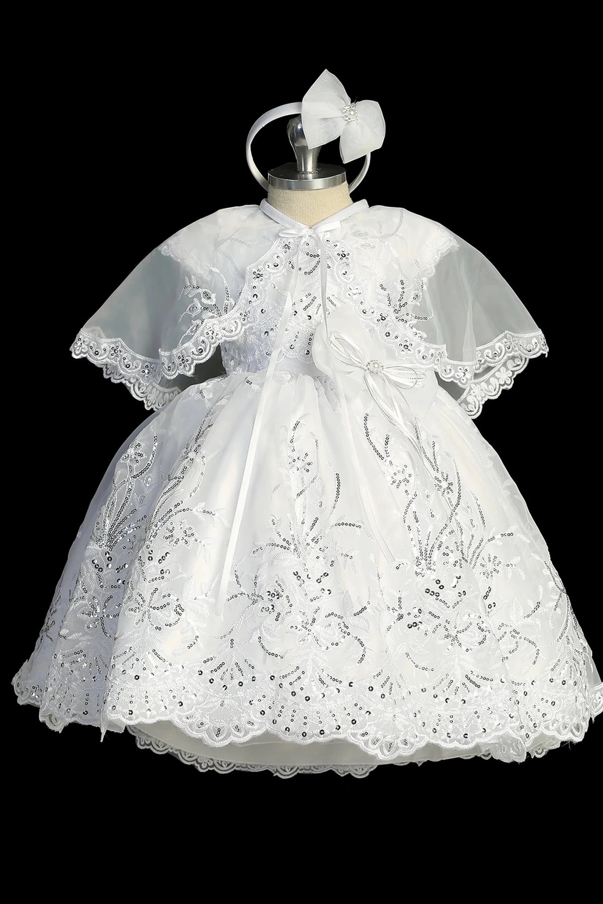 White christening dress with cap-sleeved lace bodice.
