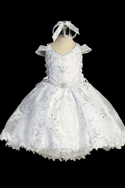 Detail of the white baptism dress showing layered second skirt with wire-hem ruffles and Virgin Mary embroidery.