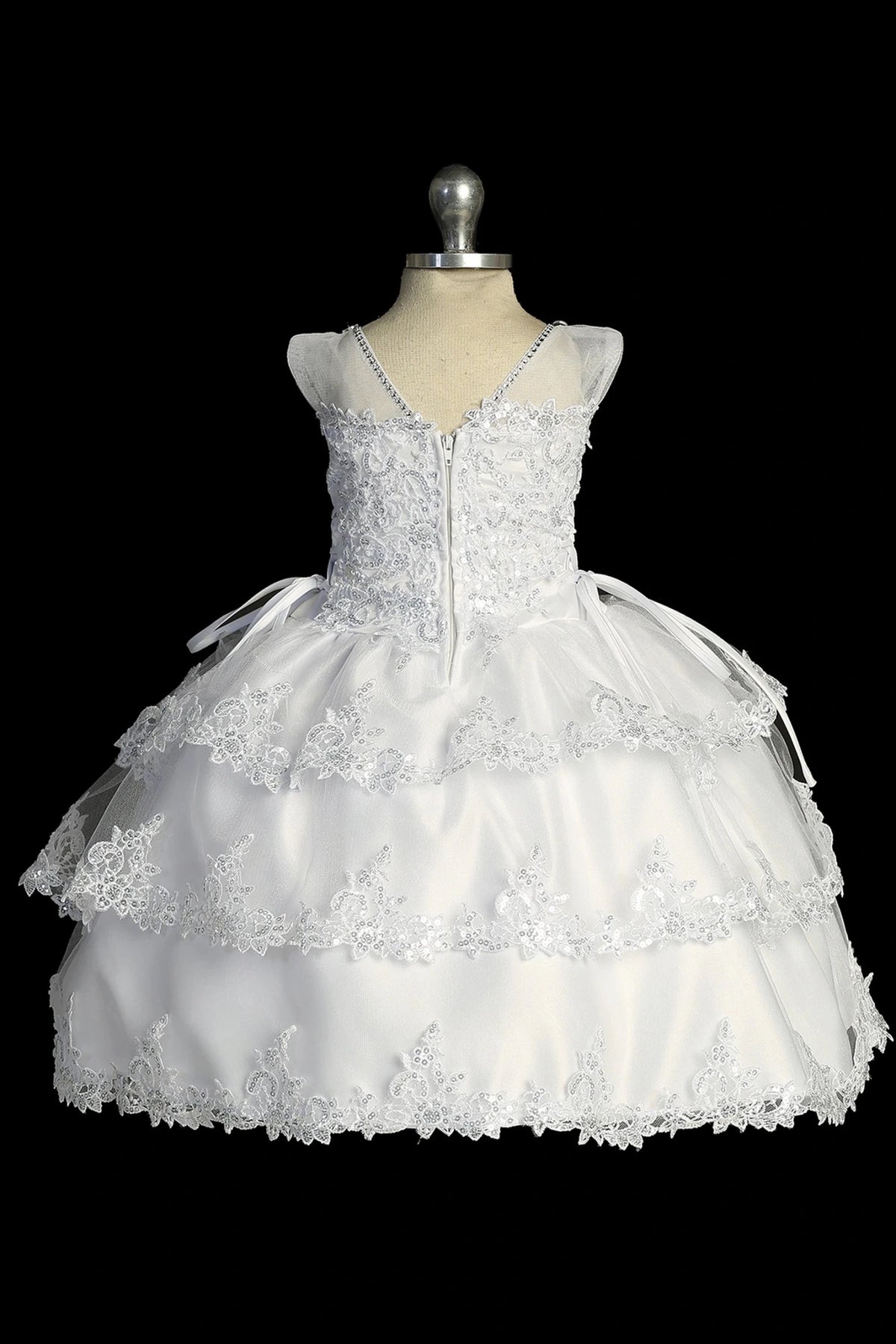 Another view of the white baptism dress with lace illusion neckline and a layered split skirt.
