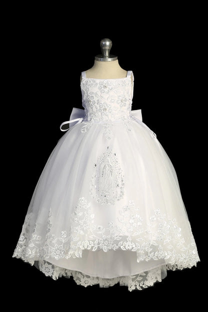 Detail of the white baptism dress showing high-low tulle skirt with lace and Virgin Mary embroidery.