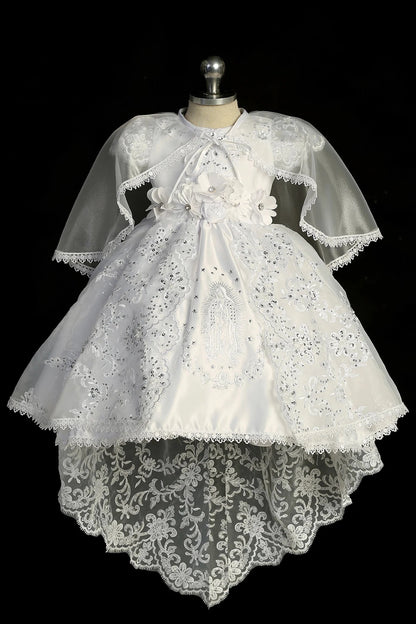 White baptism dress with cap-sleeved bodice and a scalloped split organza overlay.