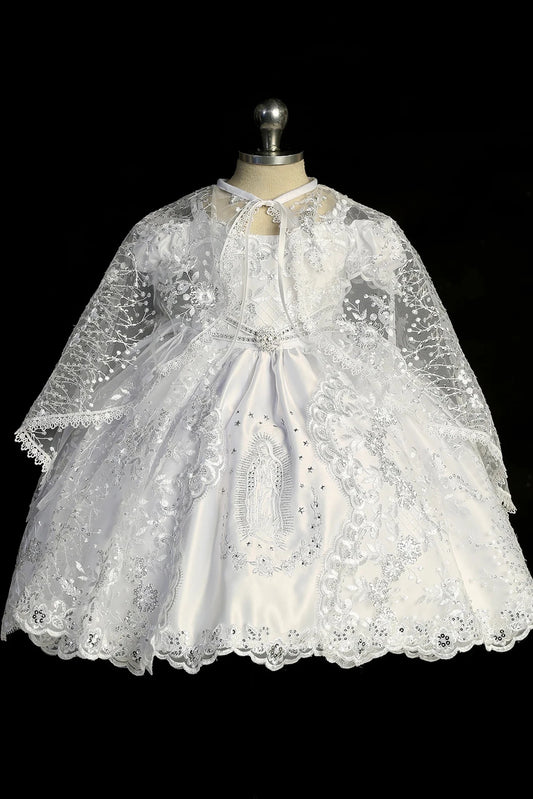 White baptism dress with short-sleeved lace bodice and a rhinestone waist accent.