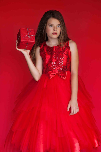 Red USA Made | Embroidered Sequined Top with Gorgeous multiple tiered skirt - front view of girl wearing dress holding a present in one hand