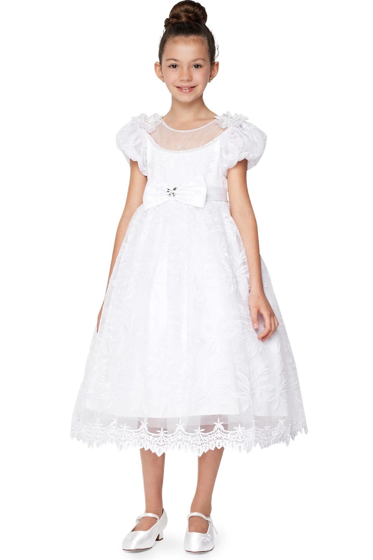 White communion dress with puff sleeves and a scalloped floral lace skirt border.