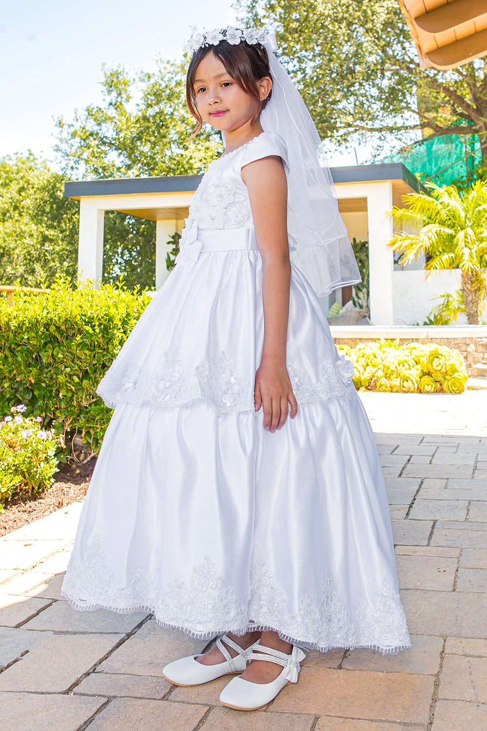 Elegant Illusion Top satin Cap Sleeve Embellished Skirt Communion Dress with Beads, Laces and Back Satin Sash - side view of girl wearing dress with hands at sides