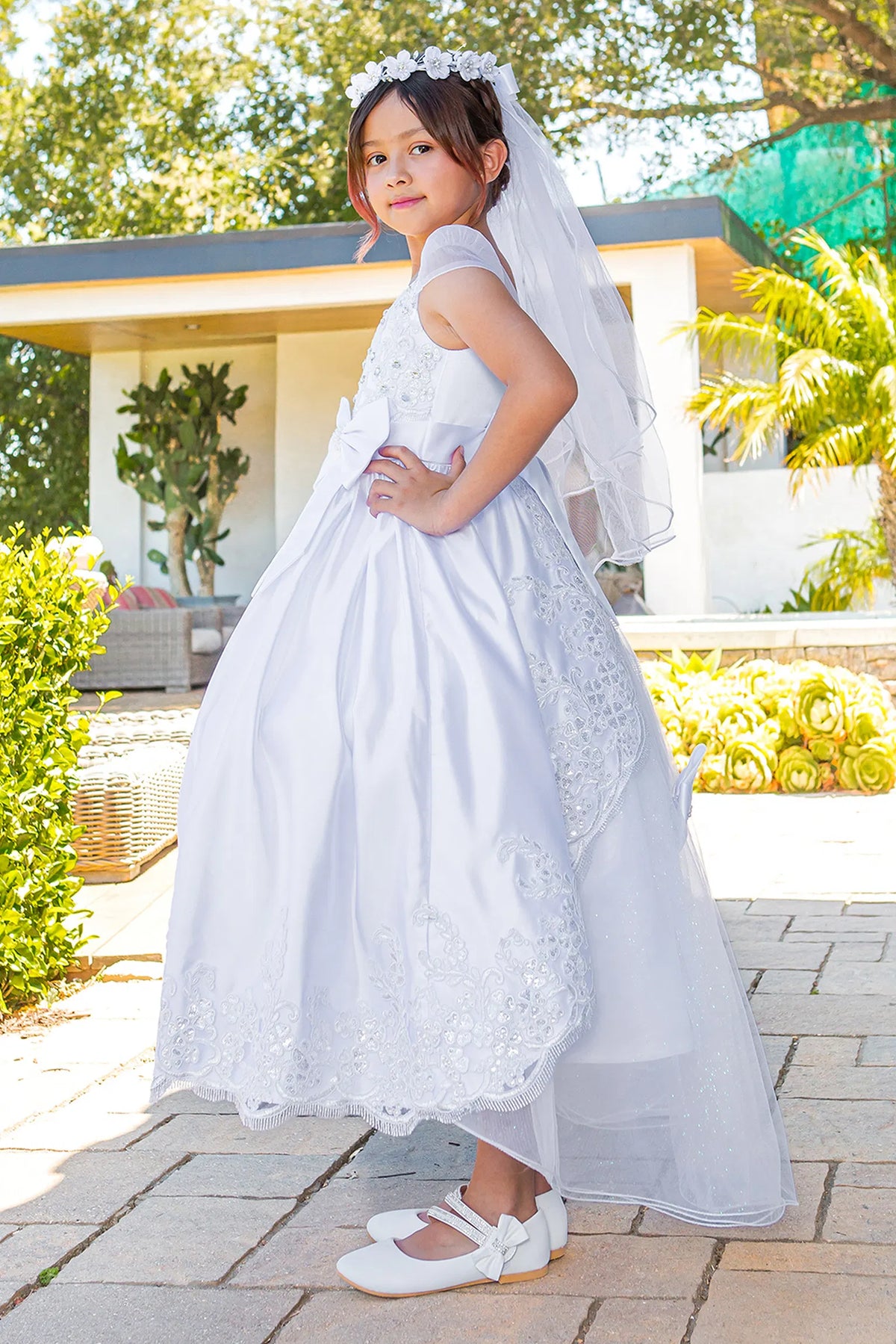 Scalloped floral lace edges the full skirt of this White communion dress.