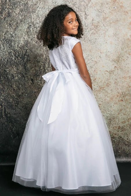 A white communion dress with a bow.
