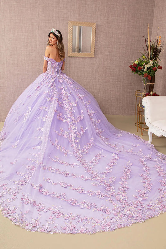 Woman in a lilac extra long train ball gown with floral details in an elegant room.