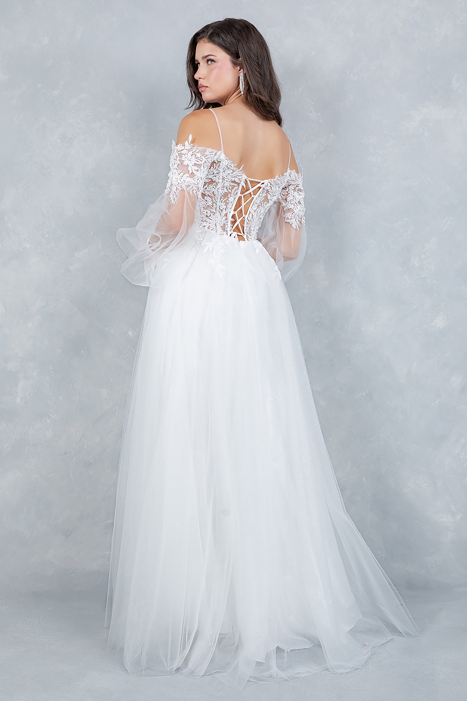 White wedding dress with lace detailing on a plain background