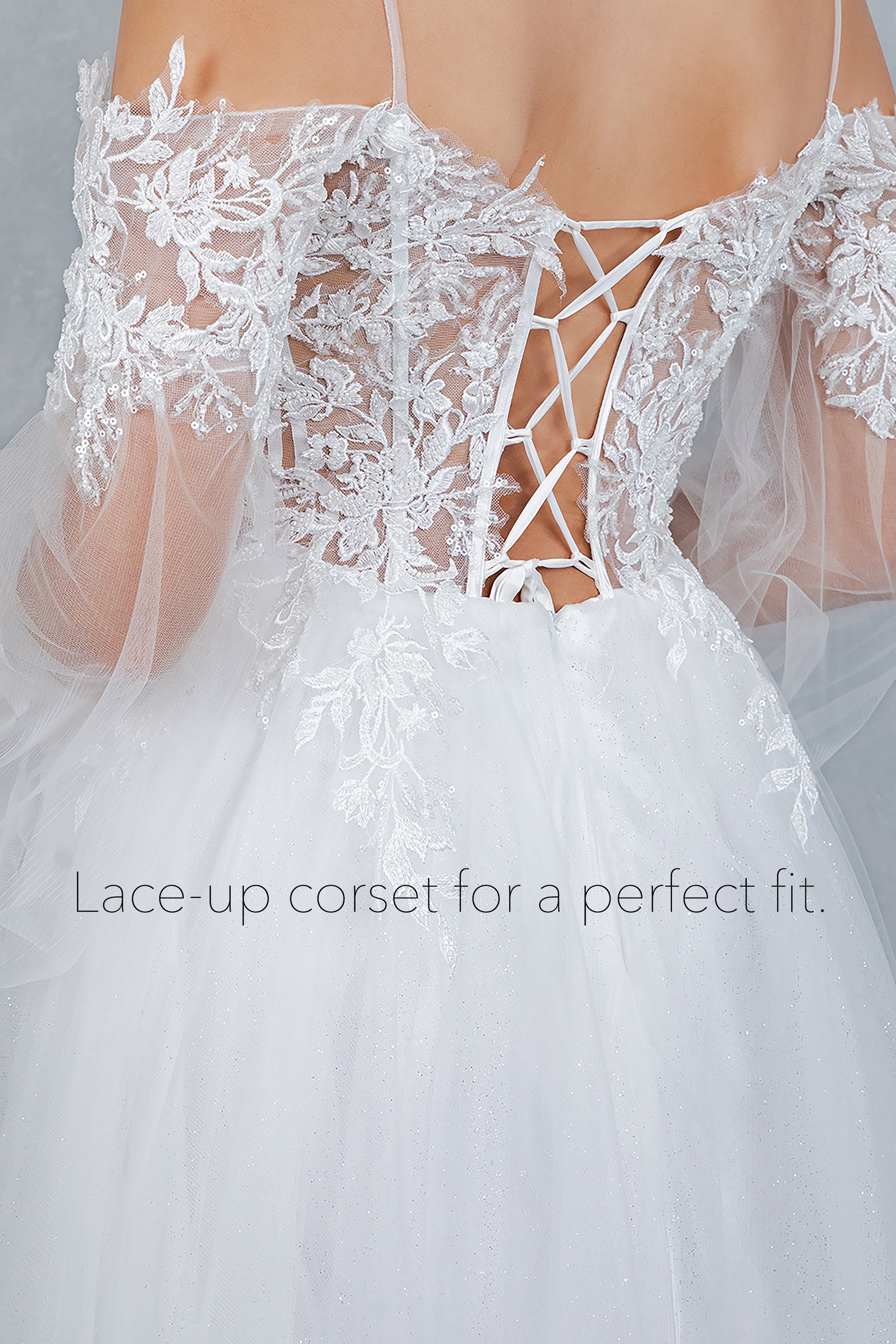 White lace-up corset with a tulle skirt, close-up view.