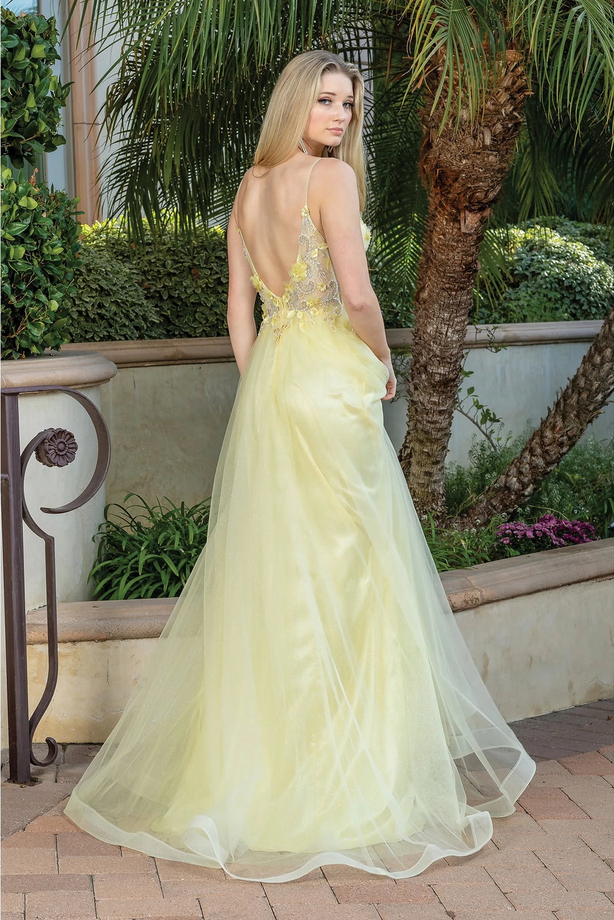 Showing its floor-length skirt, the Yellow prom dress highlights the garment construction.