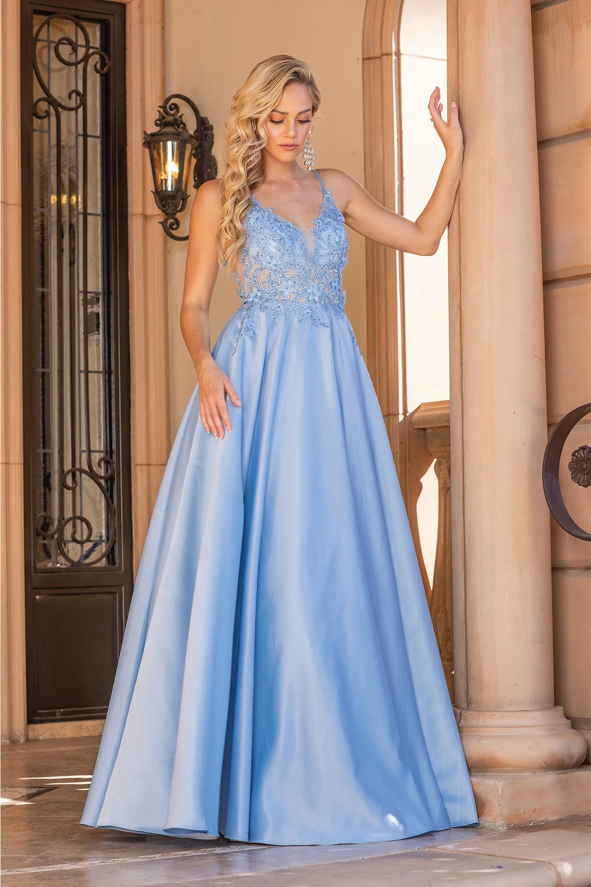 Featuring a floor-length skirt, this Bahama Blue prom dress is shown in full view.