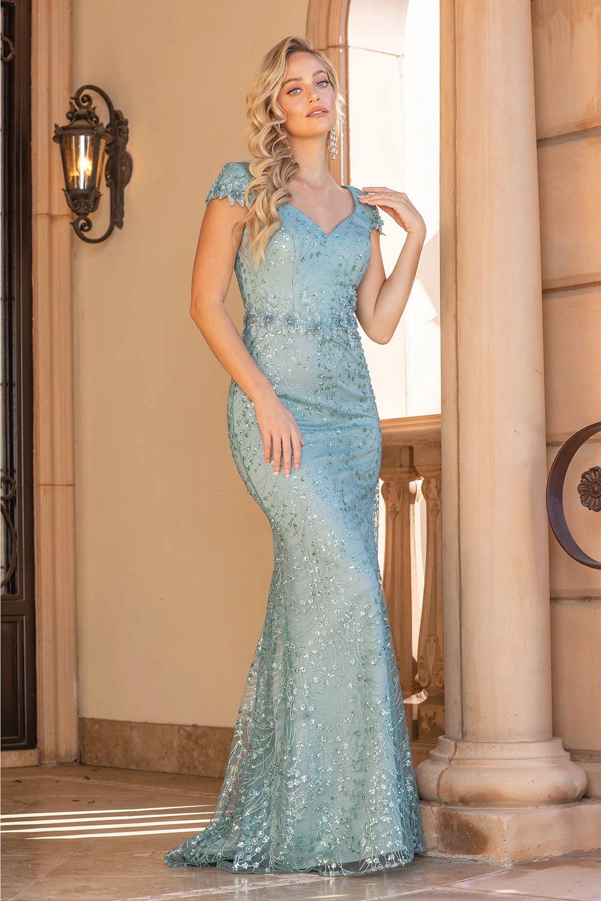 Featuring a floor-length skirt, this Sage prom dress is shown in full view.