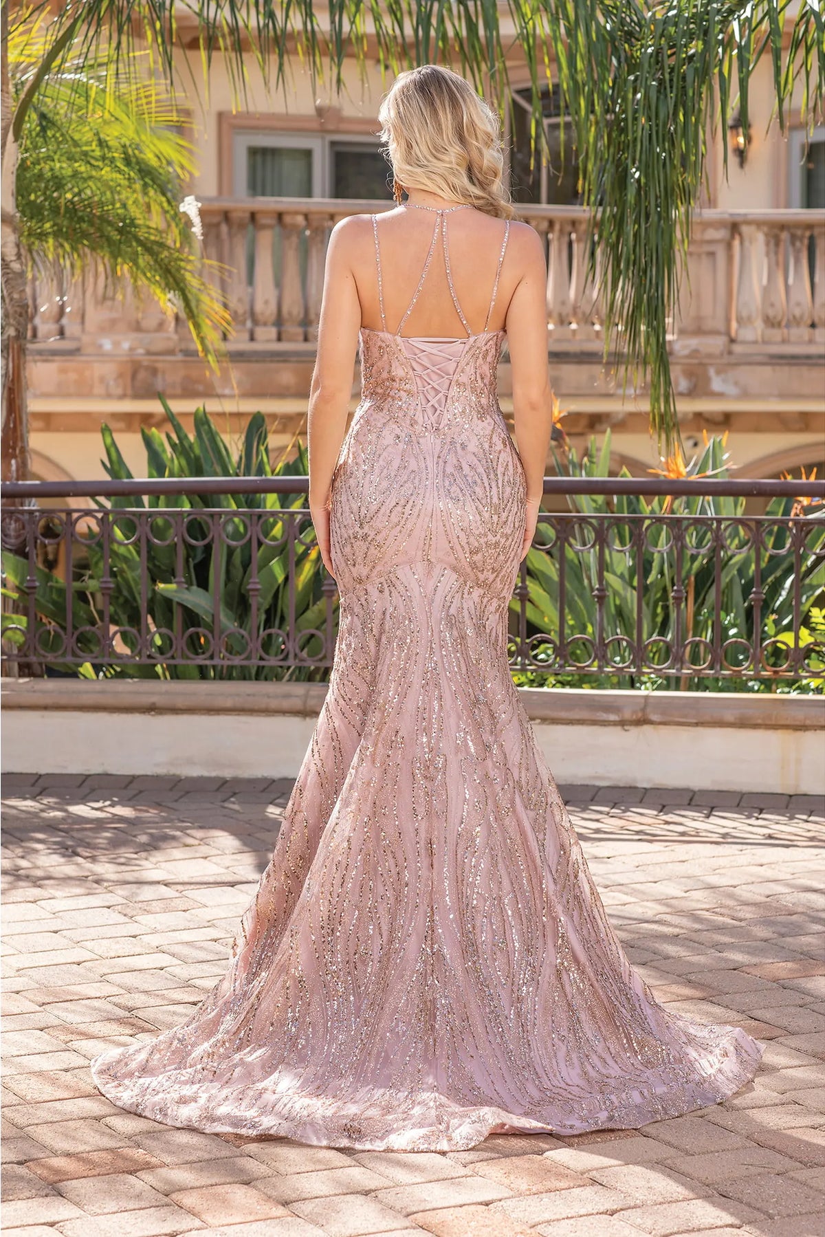 Showing its floor-length skirt, the Rose Gold prom dress highlights the garment construction.