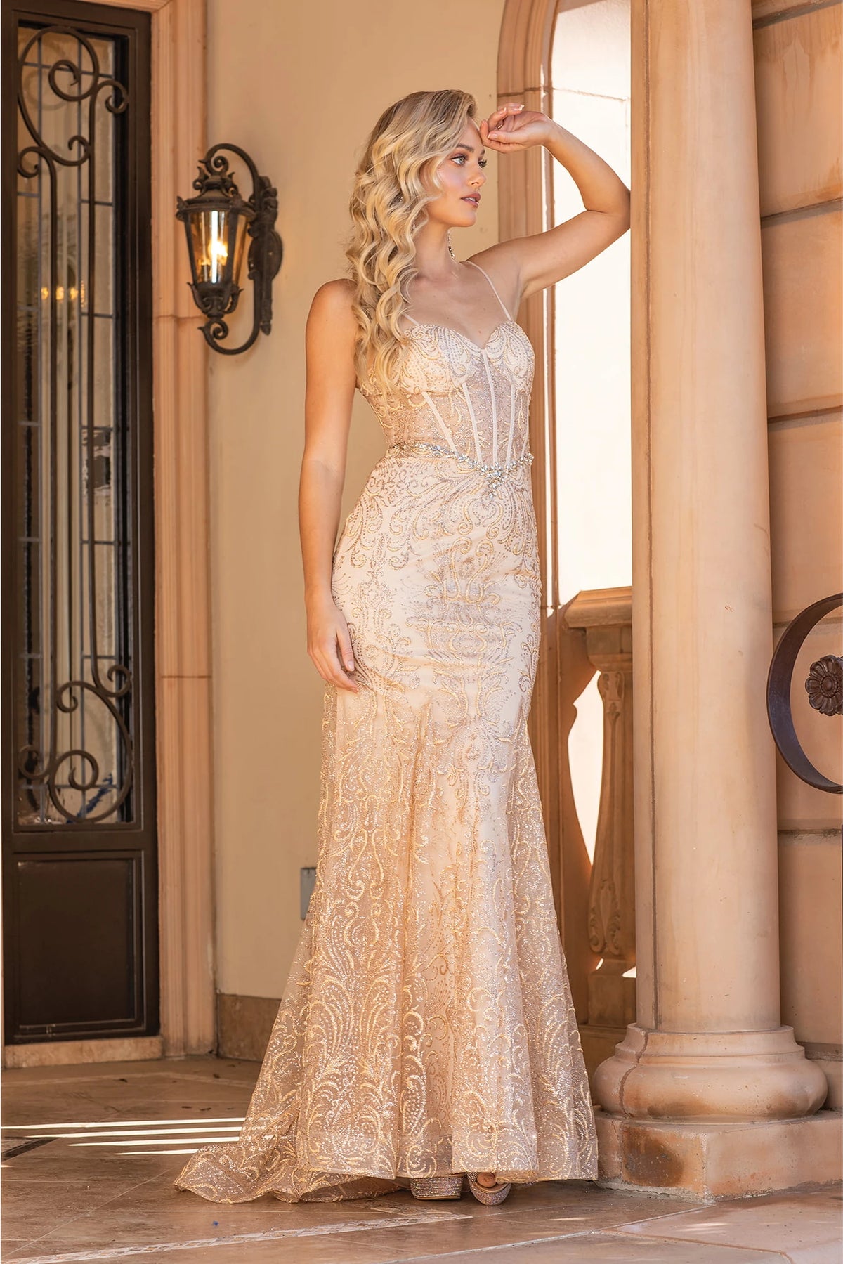 From the front, the Gold prom dress reveals its floor-length skirt.