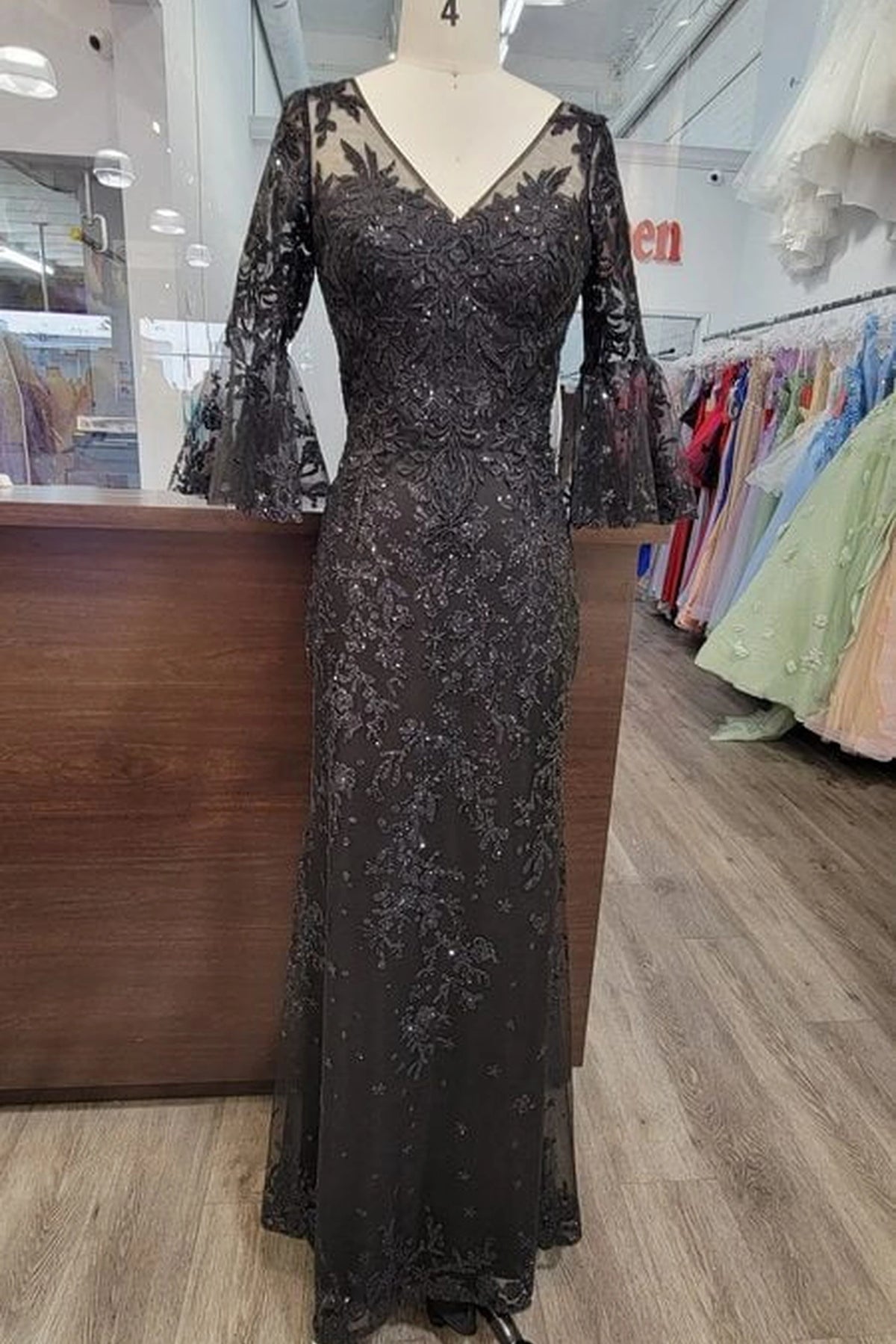 Featuring a floor-length skirt, this Black prom dress is shown in full view.