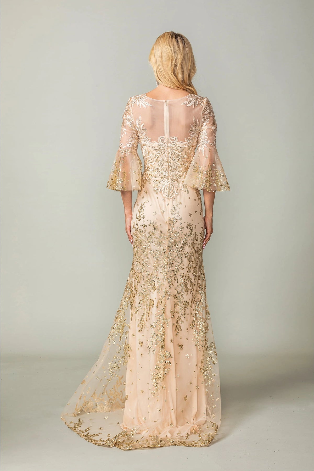 From the back, the Gold prom dress reveals its floor-length skirt.