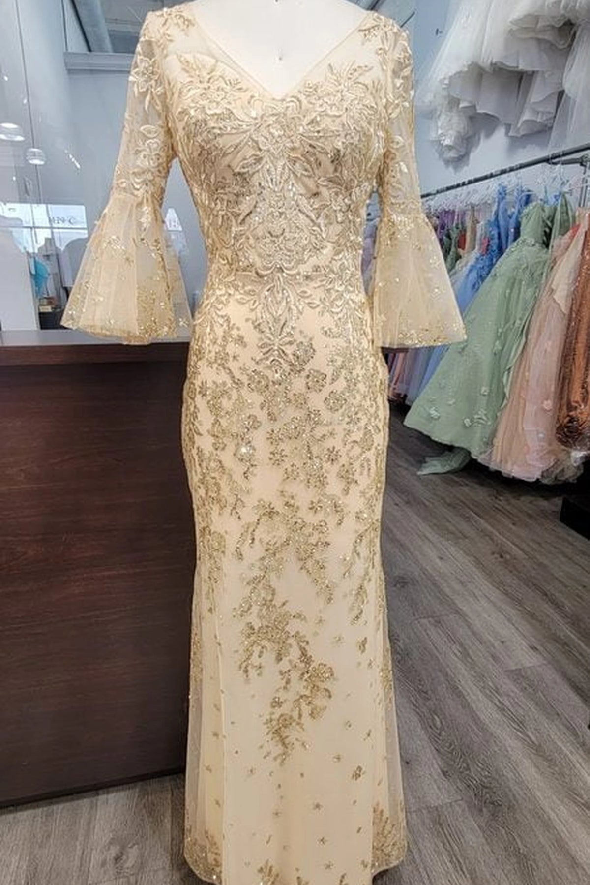 Showing its textured embellishments, the Gold prom dress highlights the garment construction.