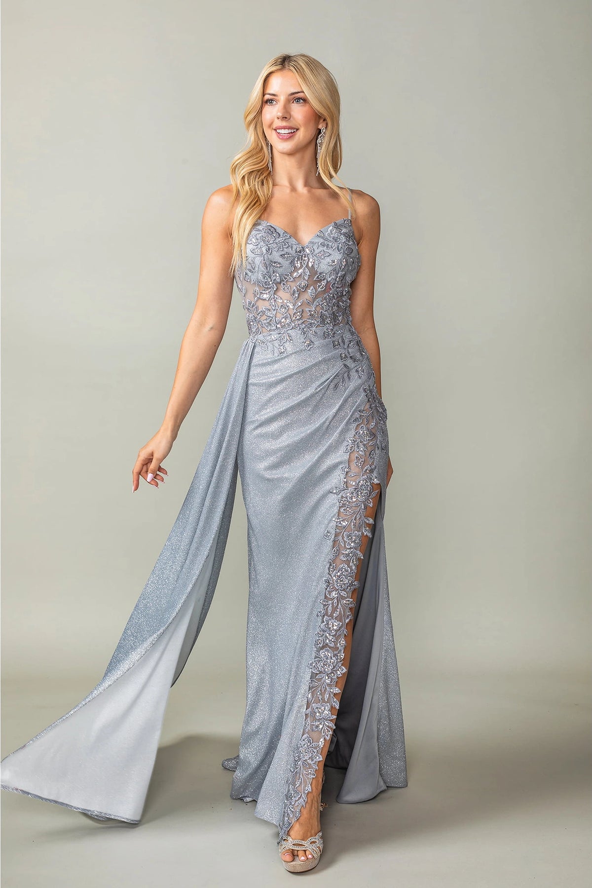 Featuring a floor-length skirt, this Silver prom dress is shown in full view.